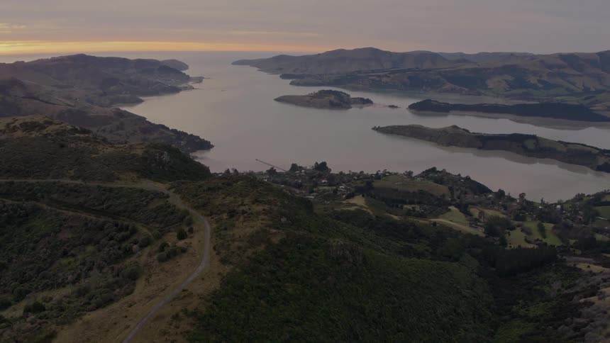 A neighborhood sits at the end of a canyon along a lake