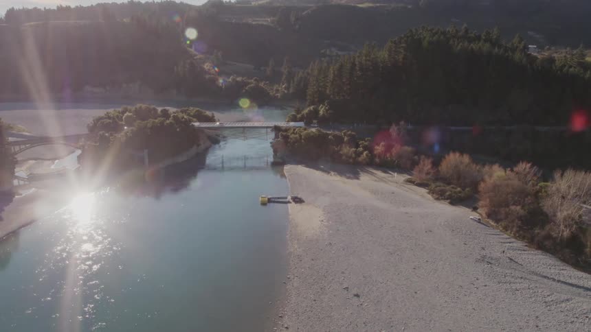 A bridge spanning a river on a bright sunny day