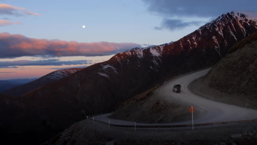 A sport utility vehicle drives up the side of a mountain