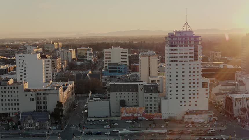 Aerial view of a downtown city at dusk is displayed
