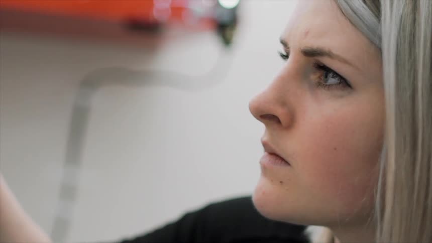 A woman is looking forward concentrating