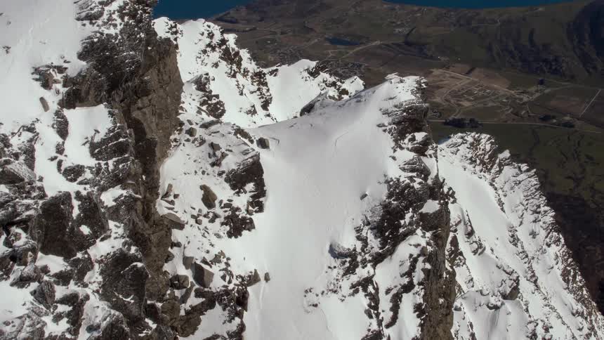 An aerial view of snow covered mountains in the wilderness