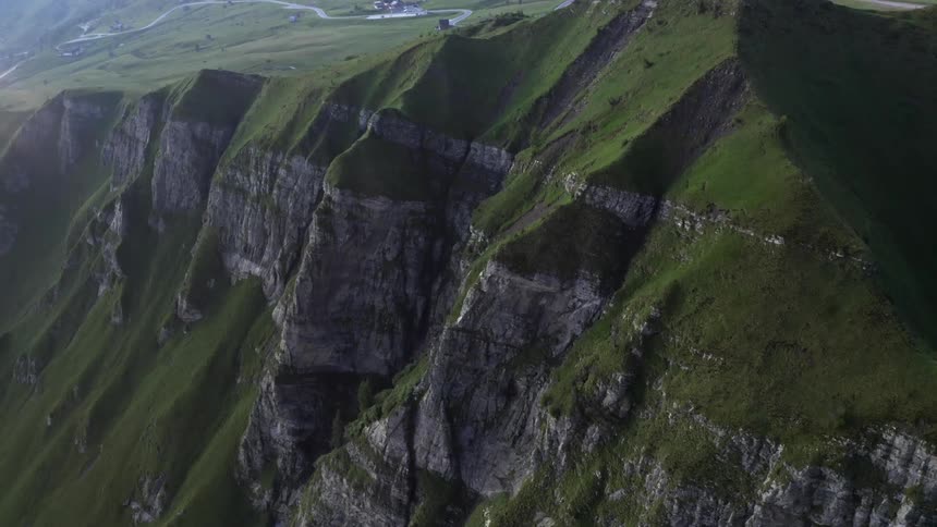 Winding road on a grass covered mountain