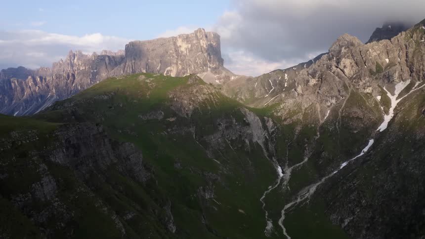 A mountain ridge covered in low vegetation on a sunny day