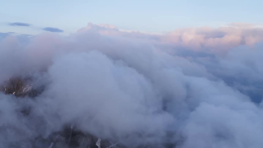Clouds float over a rocky landscape during the day