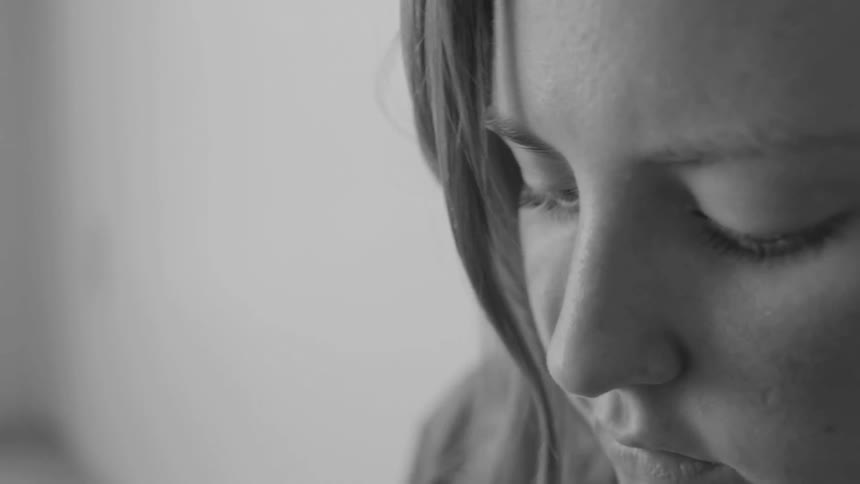 A woman concentrates on looking at something