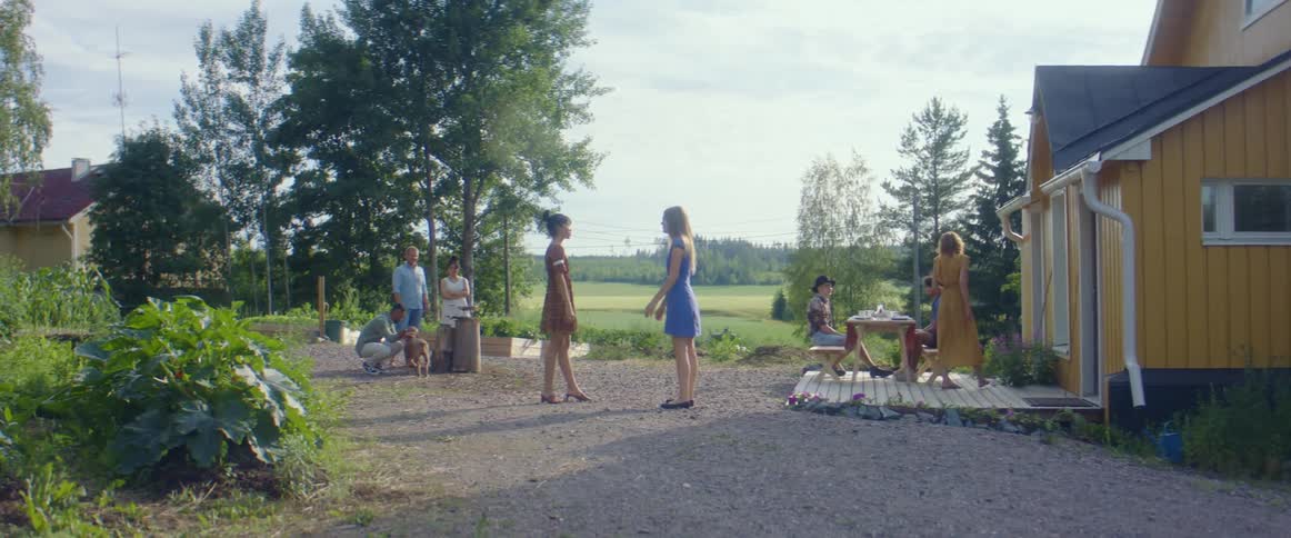 A group of people at a rural house
