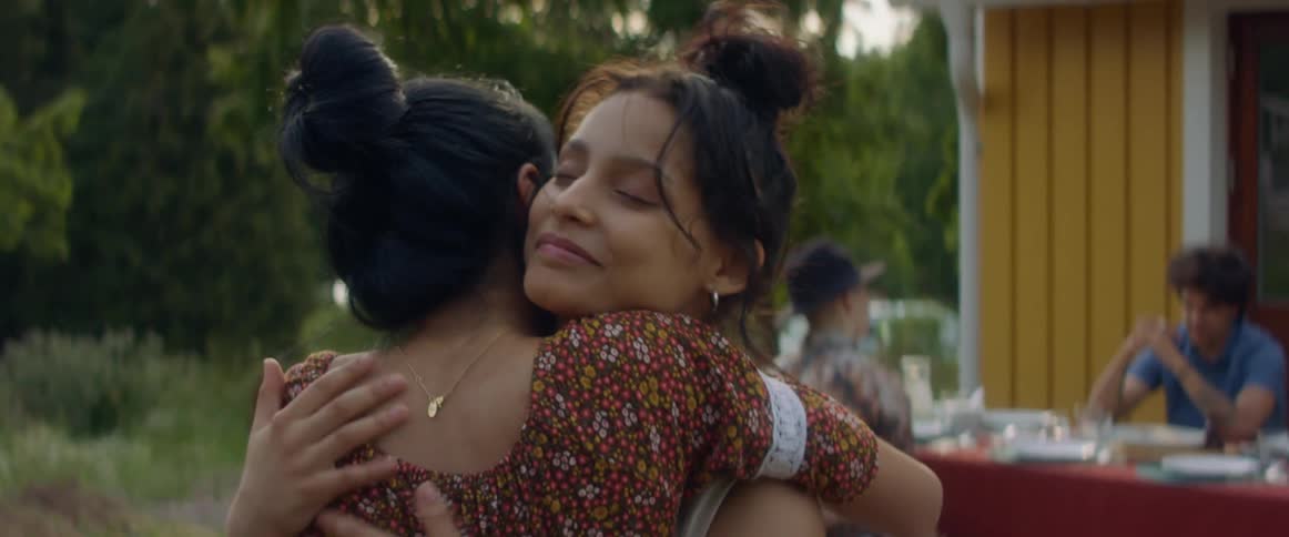 Two women hugging each other outdoors