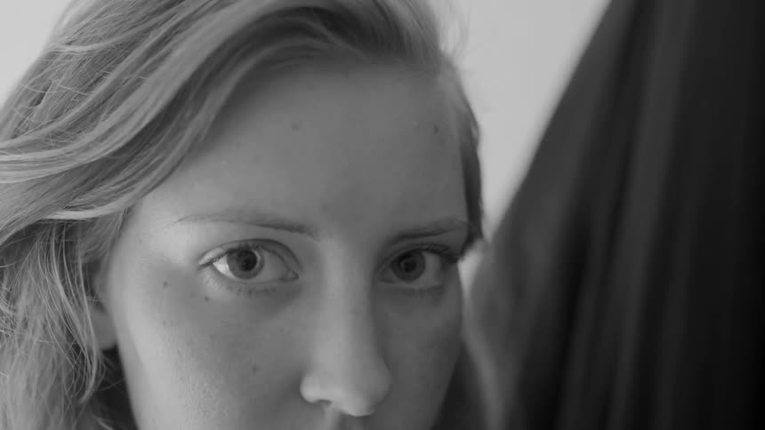 A woman is staring forward