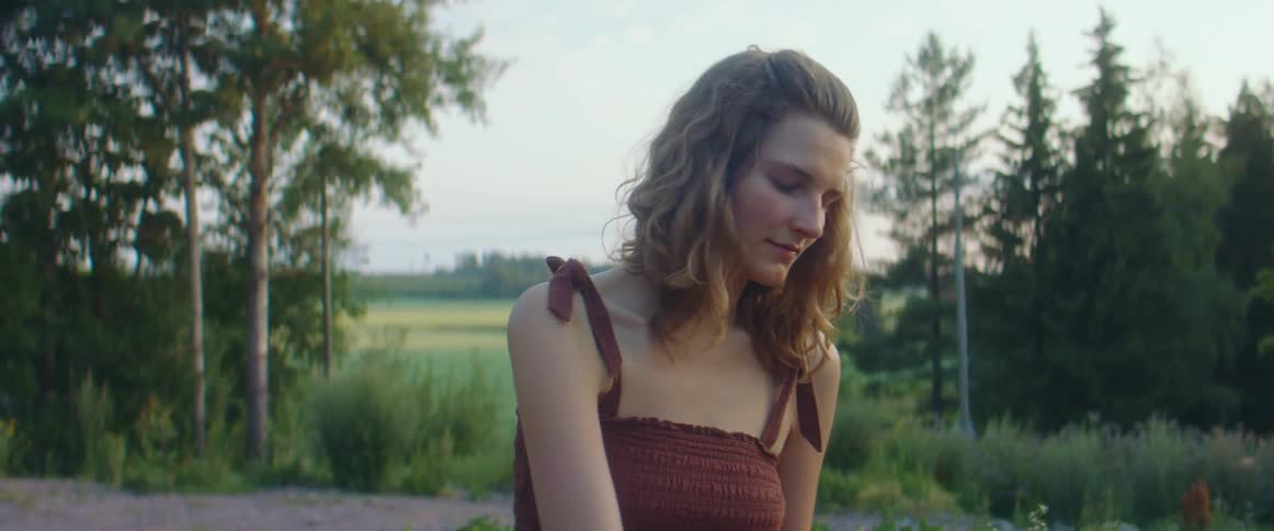 A woman is swaying back and forth in a forest