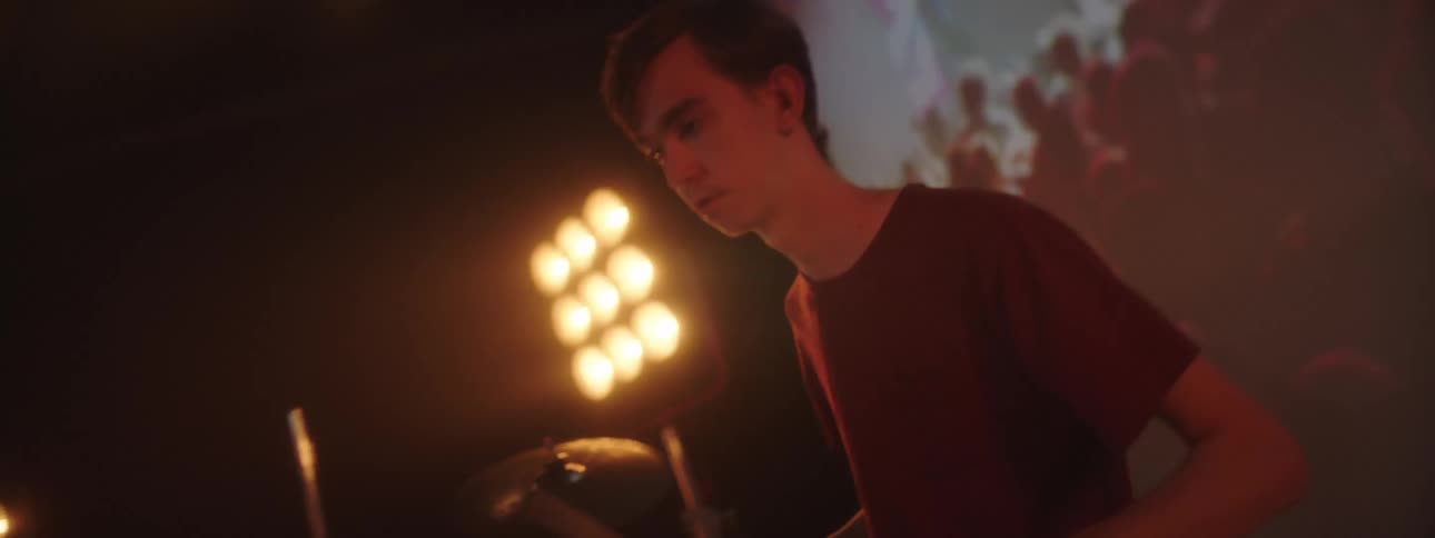 A man playing drums on a stage