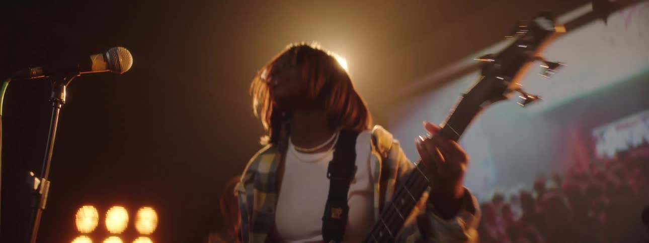 A woman playing bass on a stage