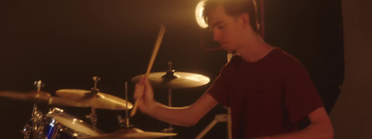 A man playing drums on a stage