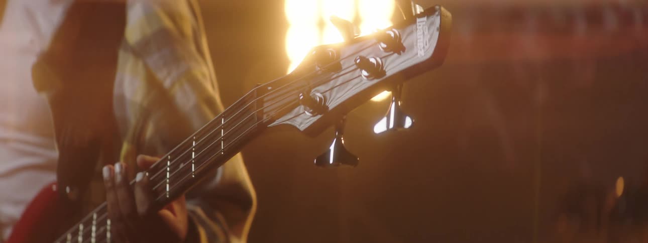 A view of a woman playing guitar on a stage