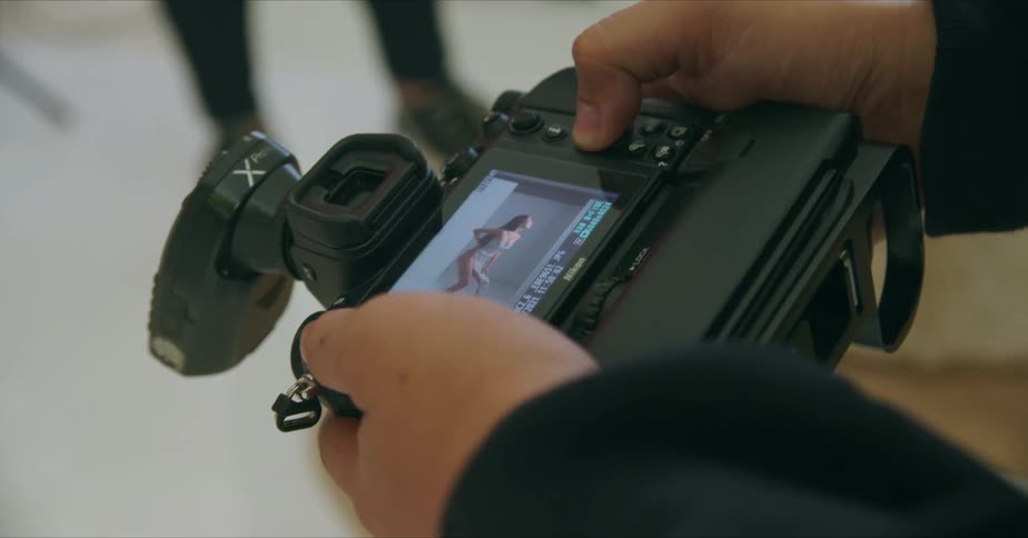 A photographer reviewing photos on a camera