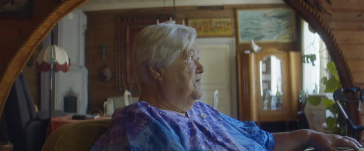An elderly woman sitting in a room