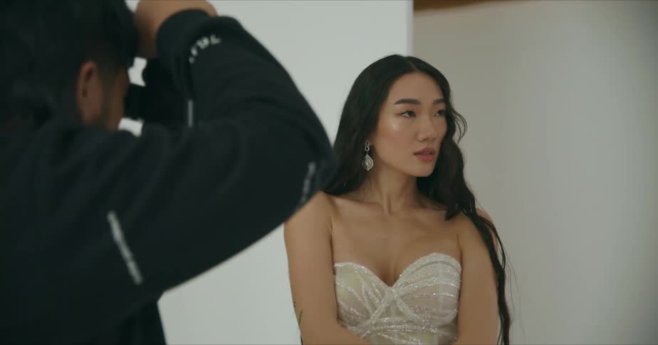 A woman is posing for a photographer