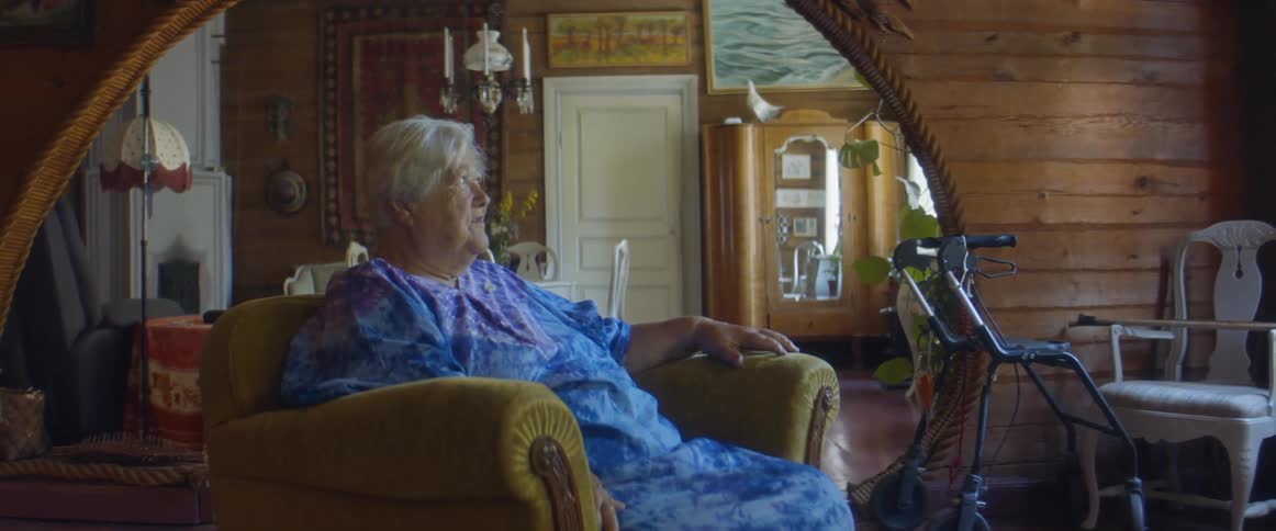 An elderly woman sitting in a chair