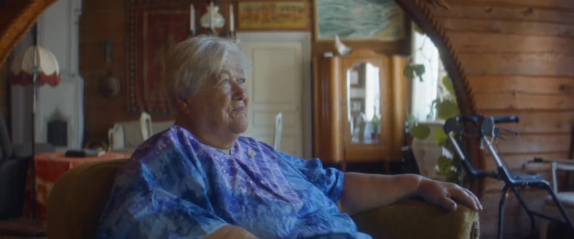 An elderly woman sitting in a chair
