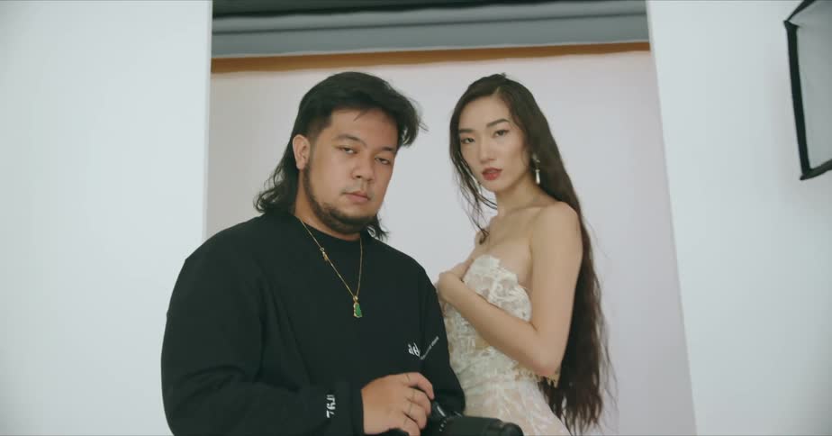 A photographer and model standing together