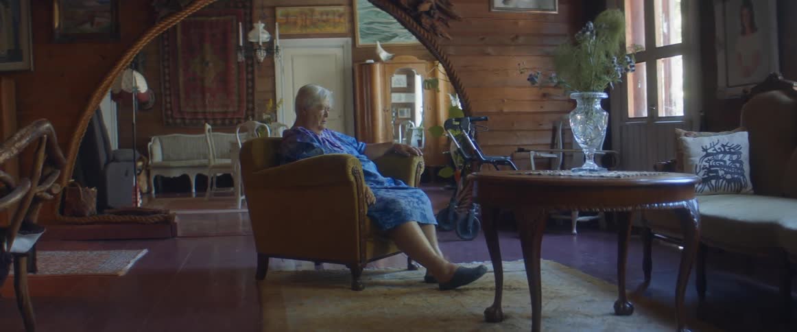 A woman sitting in a room relaxing