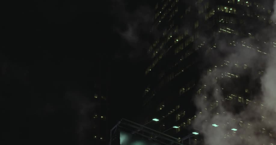 Steam rises at night in a city