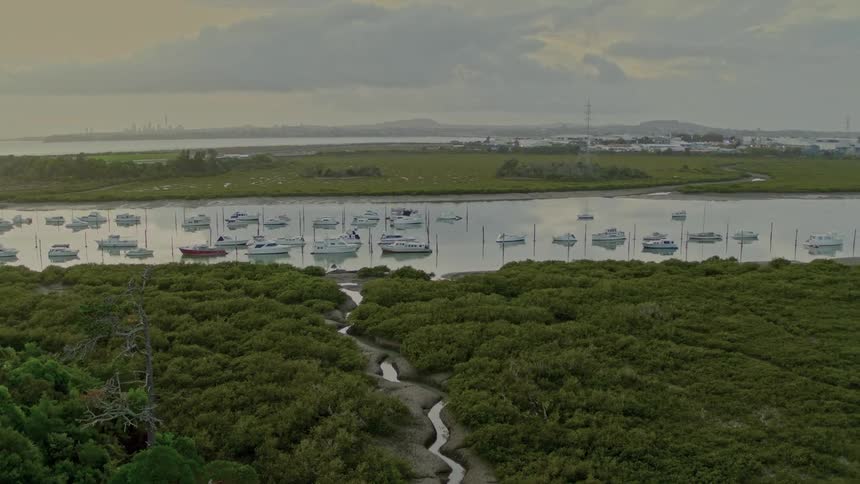An aerial view of some boats on a river