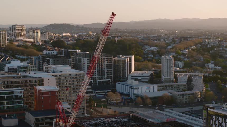 Aerial view of a crane in construction area at dusk