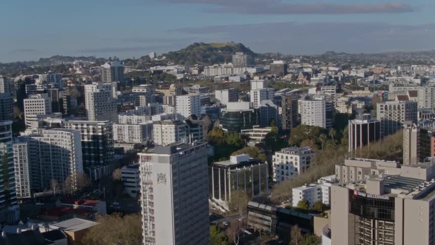Aerial view of city apartments and distant hill over the city