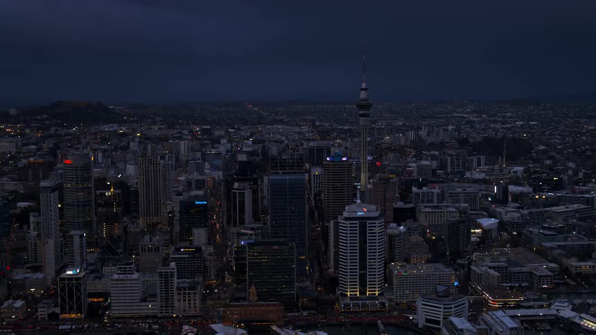 An aerial view of a city with tall buildings at night
