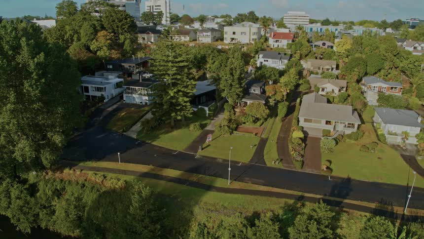 Aerial view of city town with detached houses next to river