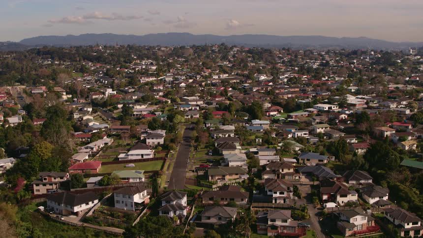 A town sprawls out in a valley near a mountain range
