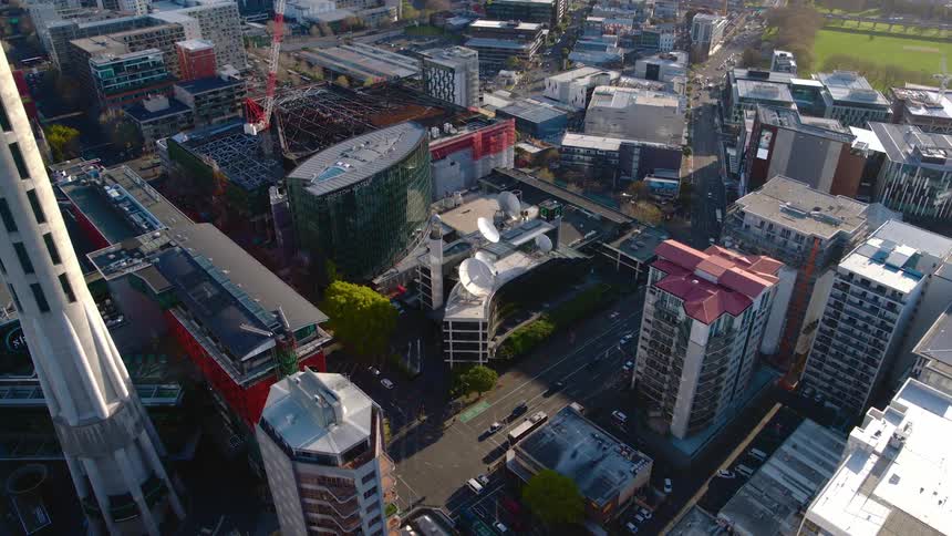 Vehicles drive through the city streets of a large urban area