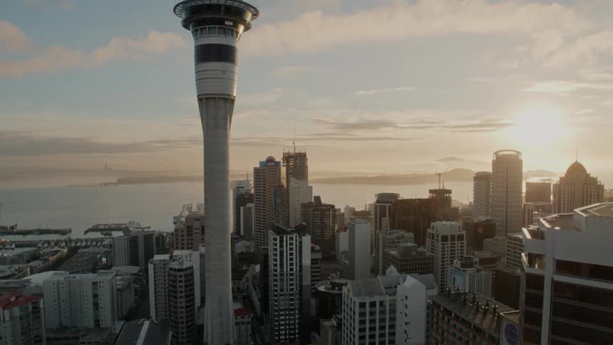 A city skyline with buildings and skyscrapers with the sky and clouds in the background