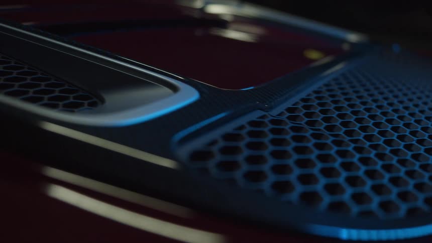 A blue light shines off the chrome trim of a vehicle