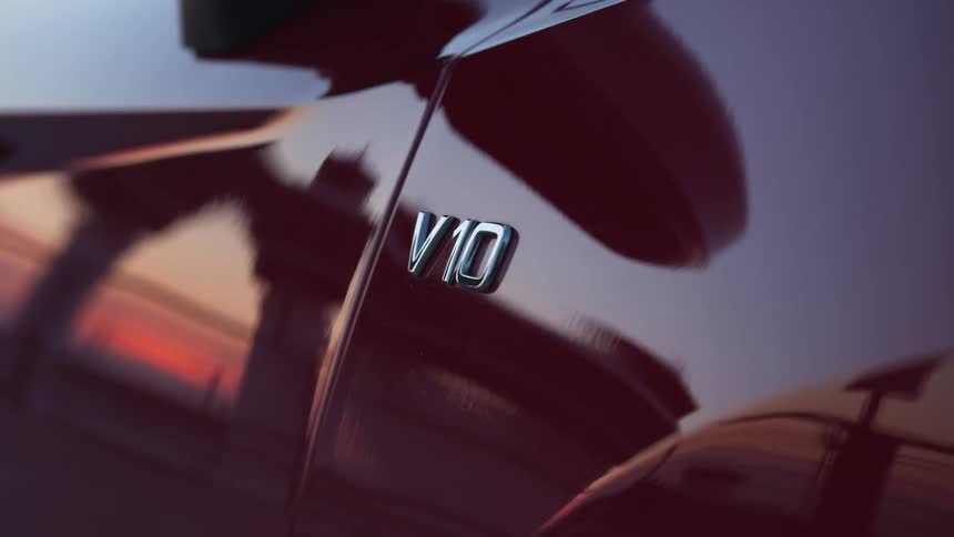The perfect paint of a v10 car reflects the sky sunset and surroundings