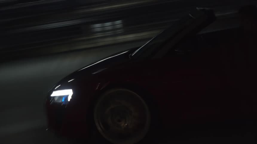 A car driving down a road at night