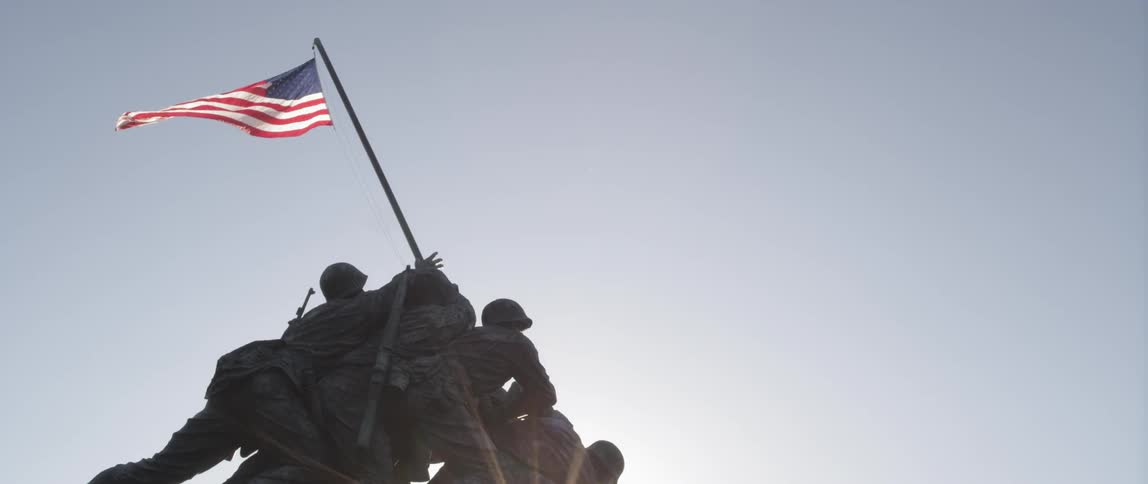 A view of the soldiers raising the flag at iwo jima statue as the flag flaps in the wind