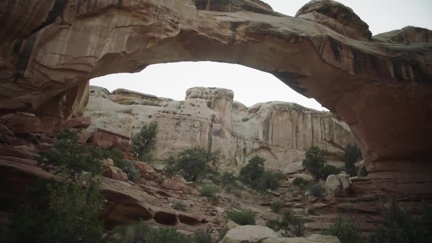 A couple is hiking through a rock formation in the mountains