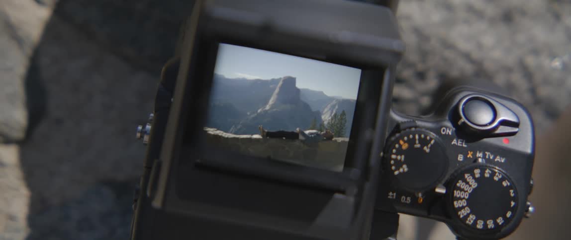 A camera is showing the last picture taken of a mountain peak