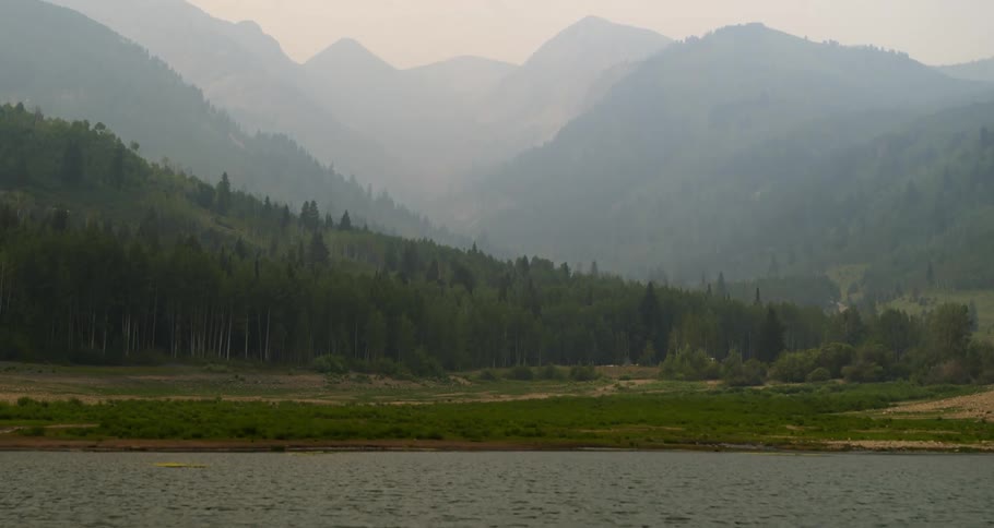 Mountains and forest sit near the lake
