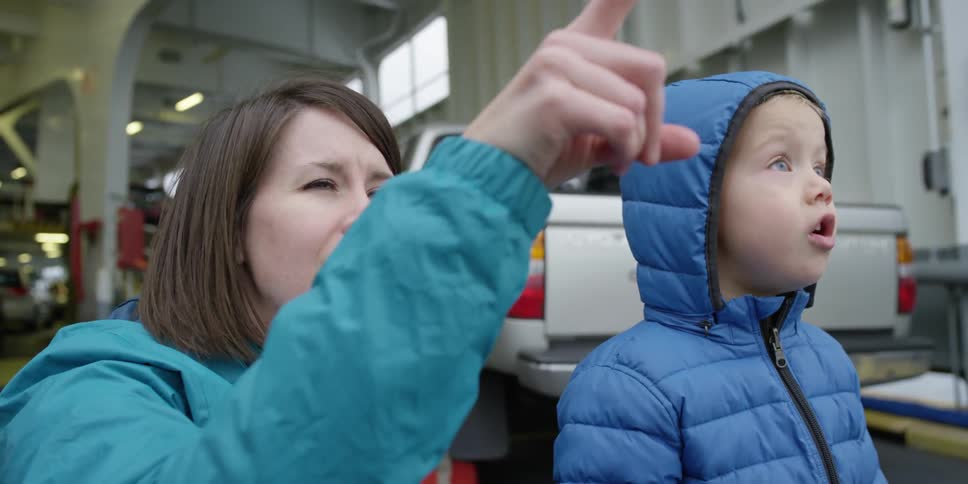 A woman is pointing things out to her son