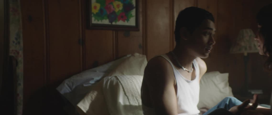 A man and woman sitting on a bed