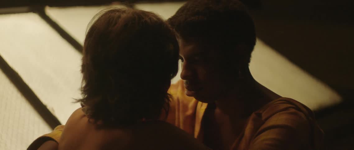 A man and a woman hugging on a rooftop