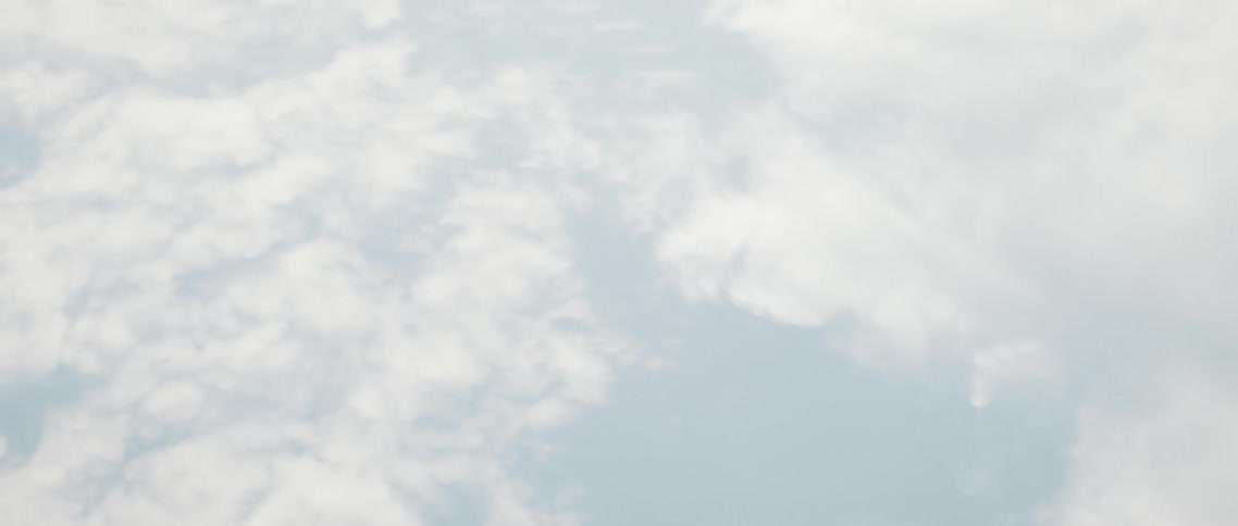 Sunlight peeks through dense clouds in the sky