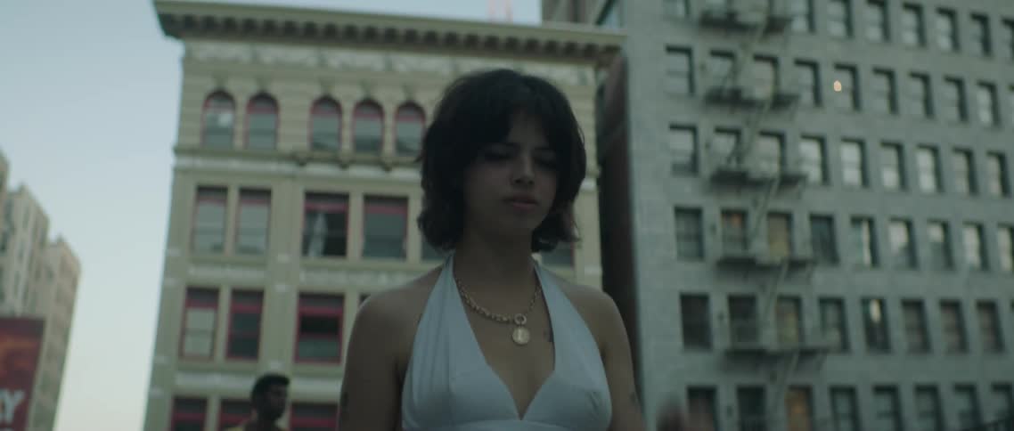 Woman walks away from her couple on the street of a city at evening