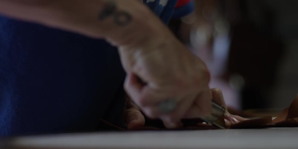 A man is cutting something in a shop