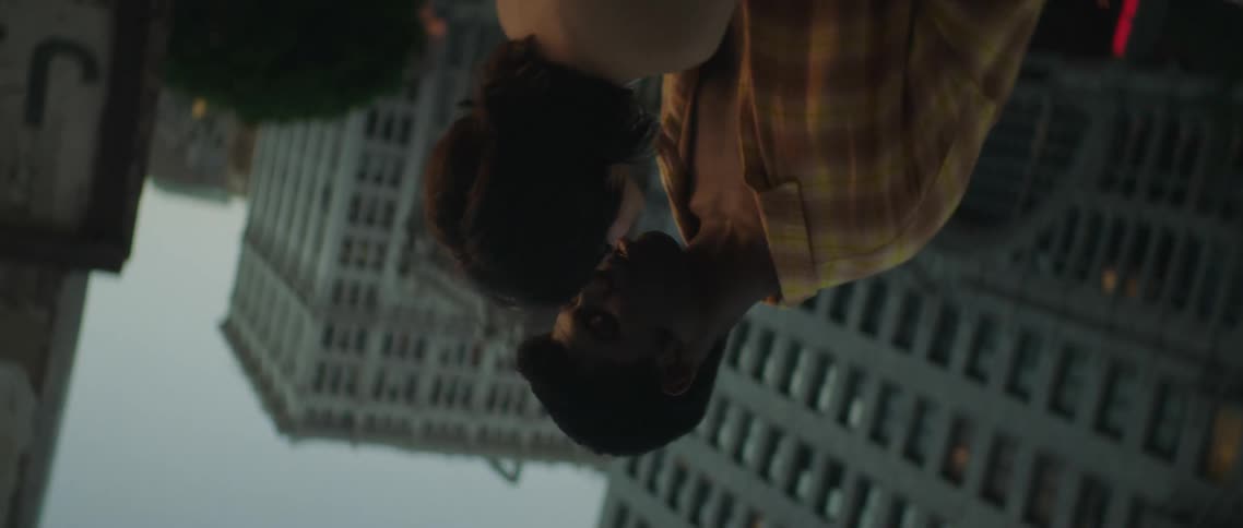 A couple hold each other on the roof top