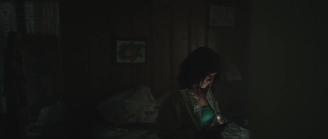 A woman paces in her bedroom while using her smartphone