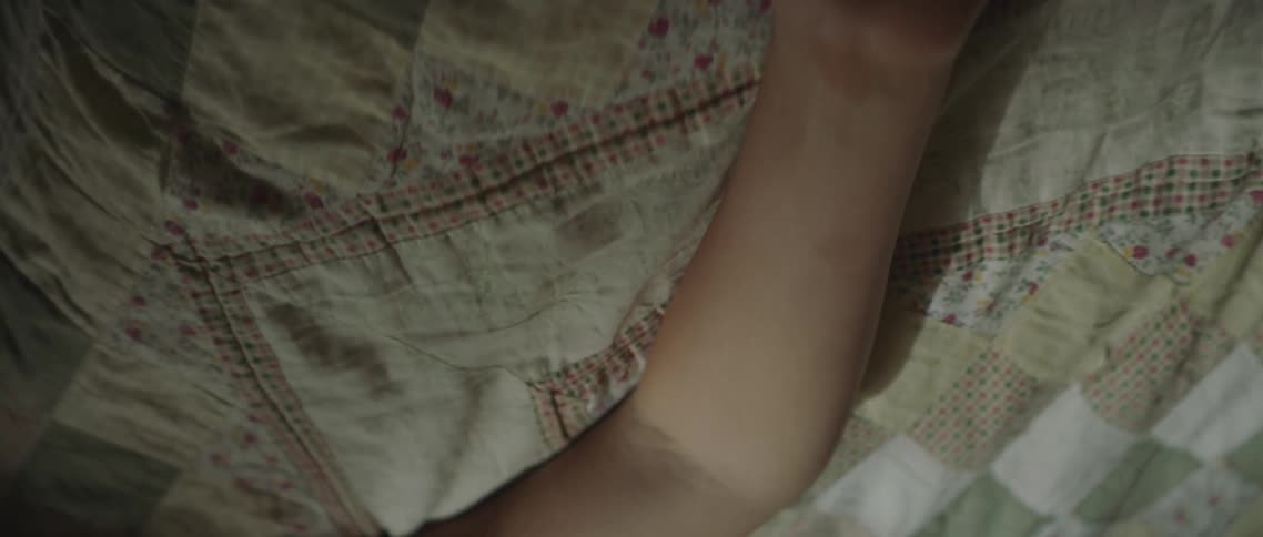 A woman laying on a bed resting